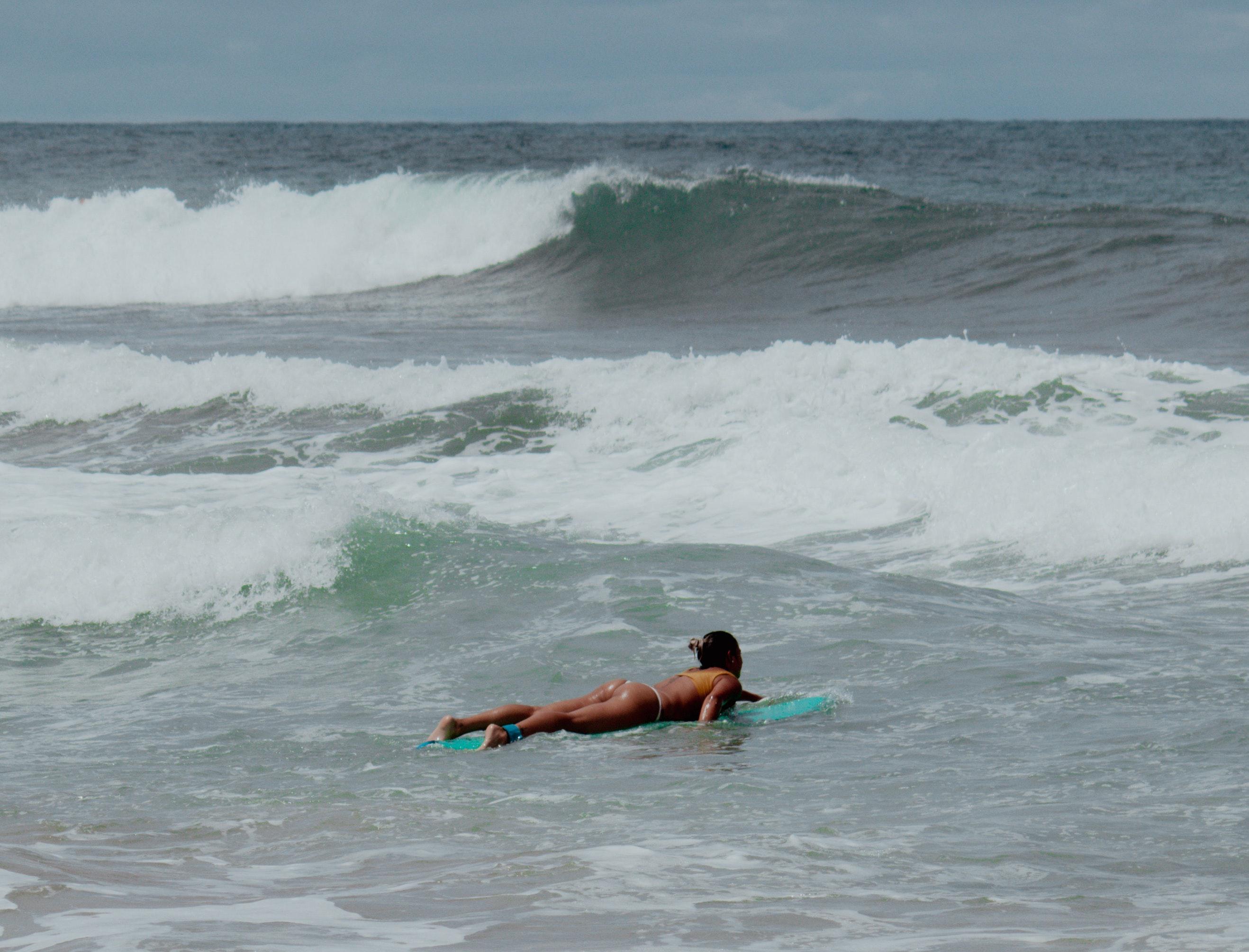 woman surfing in costa rica